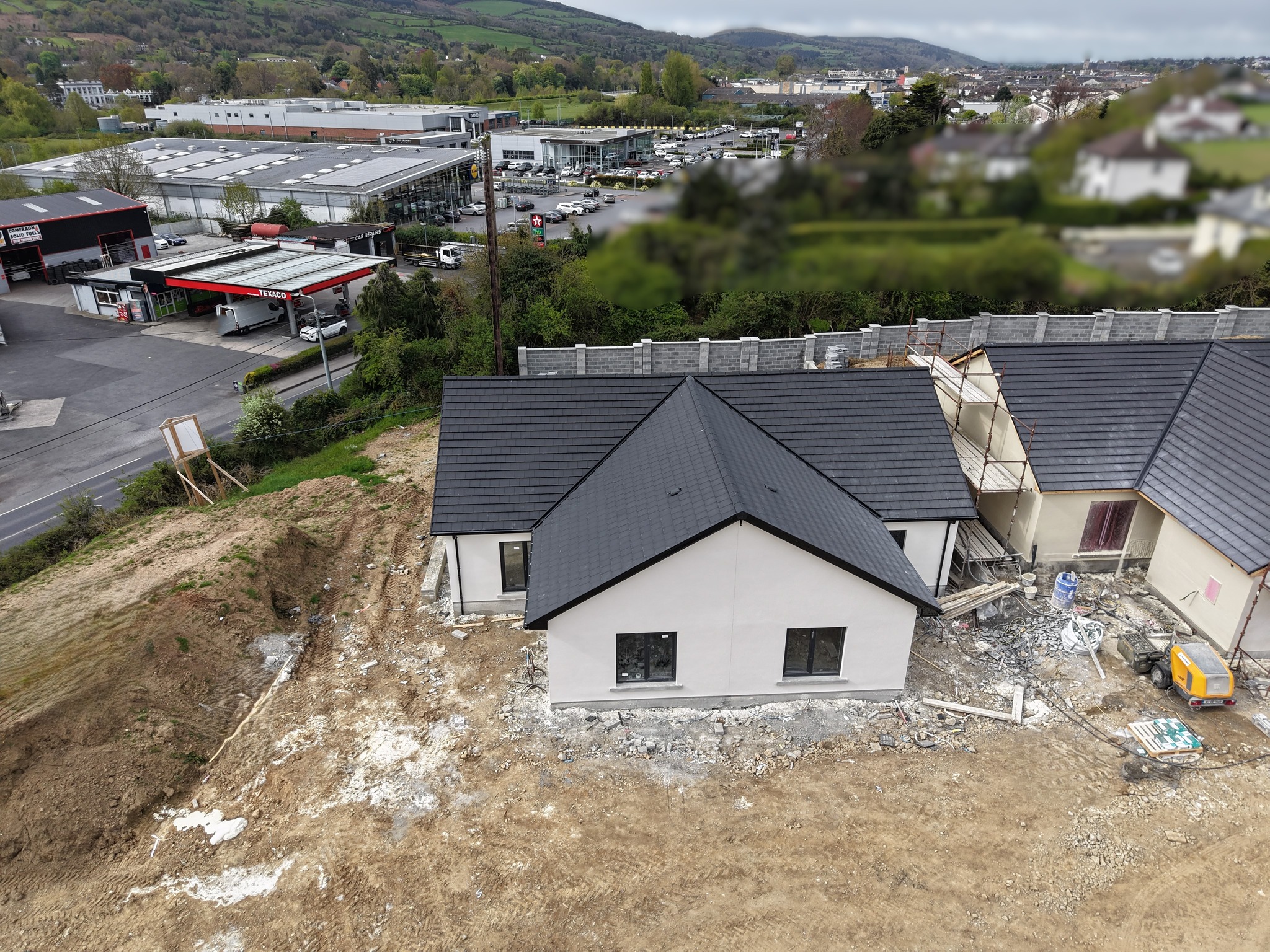 drone shot of a house under construction in Drumquin housing development in Clonmel with the Texaco garage and the Davis road Clonmel in the background.
